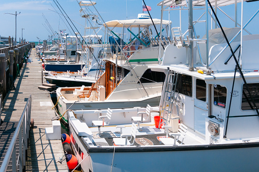 Orleans, Massachusetts, USA -May 26, 2021- The dock at Rock Harbor in Orleans is home to several sport fishing boats which are available for fishing expeditions in Cape Cod bay