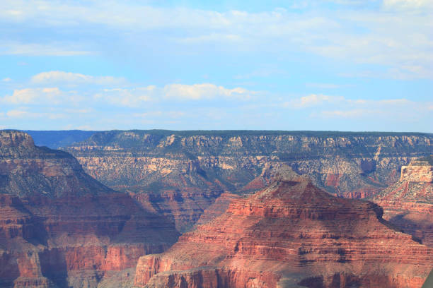 Rock Outrops an Cliffs Landscape of the Grand Canyon Under Blue Clouded Sky stock photo