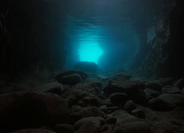 Rocks underwater inside a cave natural scene stock photo