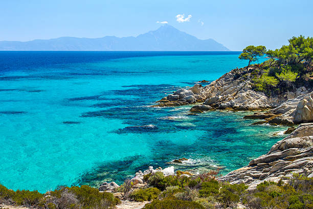 Rocky coastline and a beautiful clear water at Halkidiki Kassand Rocky coastline and a beautiful clear water at Halkidiki Kassandra peninsula in Greece peninsula stock pictures, royalty-free photos & images