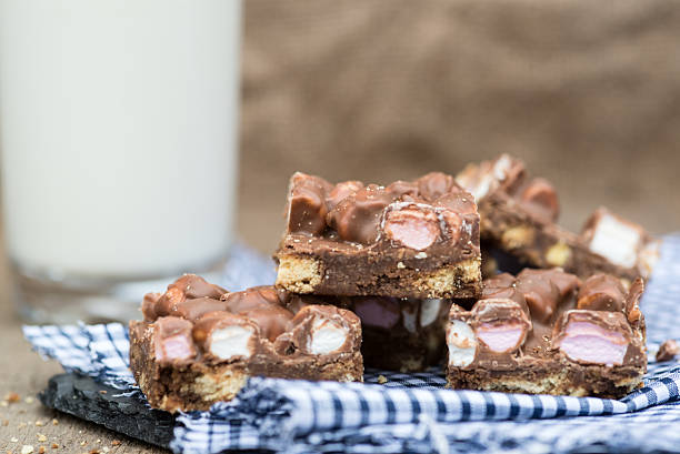 rocky road dessert squares and glass of milk stock photo