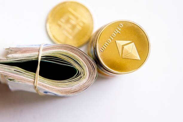 Roll banknotes near cryptocurrency tokens Ethereum eth, saw from above, on white background. Selective focus. with space for text placement. Isolated Roll Israeli Shekel ILS banknotes near cryptocurrency tokens Ethereum eth, saw from above, on white background. Selective focus. with space for text placement. Isolated . High quality photo  With Ethereum  stock pictures, royalty-free photos & images