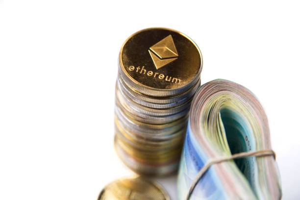 Roll Israeli Shekel ILS banknotes near cryptocurrency tokens Ethereum eth, saw from above, on white background. Selective focus. with space for text placement. Isolated Roll Israeli Shekel ILS banknotes near cryptocurrency tokens Ethereum eth, saw from above, on white background. Selective focus. with space for text placement. Isolated . High quality photo With Ethereum stock pictures, royalty-free photos & images