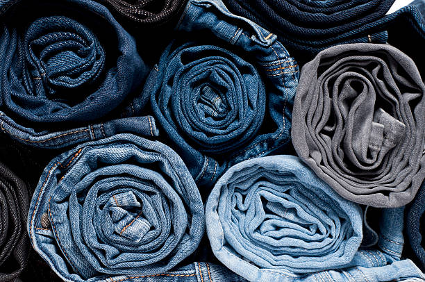 Rolled Denim Jeans Stack of rolled jeans textile industry photos stock pictures, royalty-free photos & images