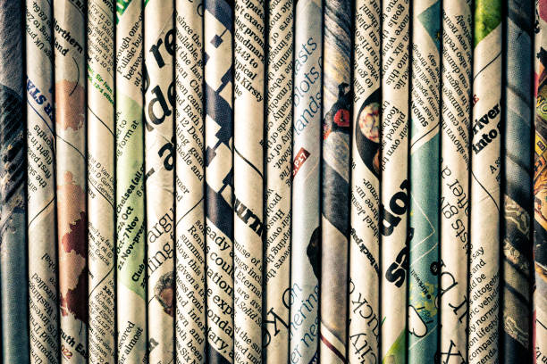 Rolled newspaper pages abstract background stock photo