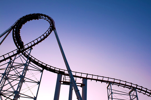 The scaring loops of a rollercoaster at sunset.