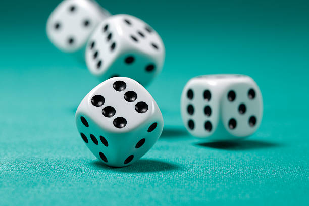 Rolling Dice on Felt Table slight motion blur and depth of field dice stock pictures, royalty-free photos & images