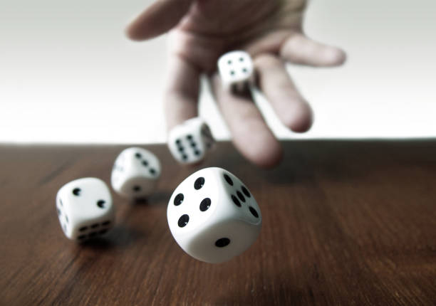 Rolling Dices Rolling Dices & Hand dice stock pictures, royalty-free photos & images
