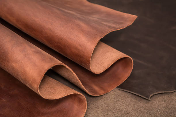 Rolls of natural brown and black leather. Materials for leather craft. stock photo