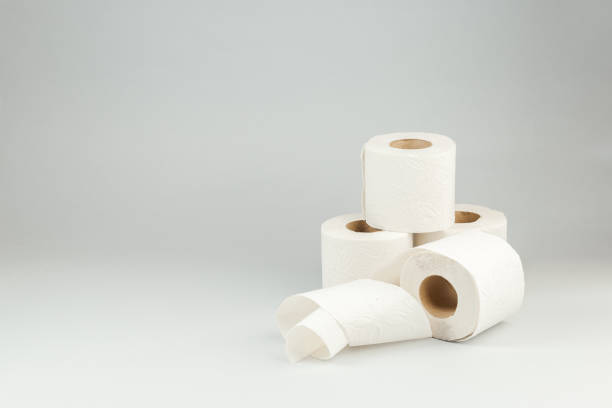 Rolls of Soft Toilet Paper over Gray Background stock photo