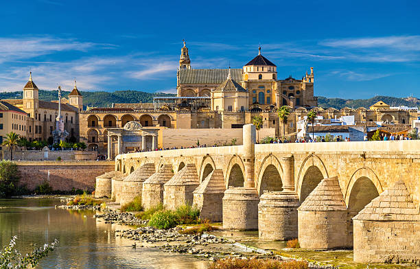 Roman Bridge across the Guadalquivir river and Mosque-Cathedral in The Roman Bridge across the Guadalquivir river and the Mosque-Cathedral in Cordoba, Spain cordoba mosque stock pictures, royalty-free photos & images