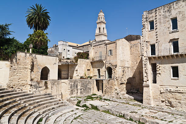 Roman Theatre in Lecce old town Lecce, Apulia (Italy).  Romanic teather in old town with view of Dome towerbell. lecce stock pictures, royalty-free photos & images