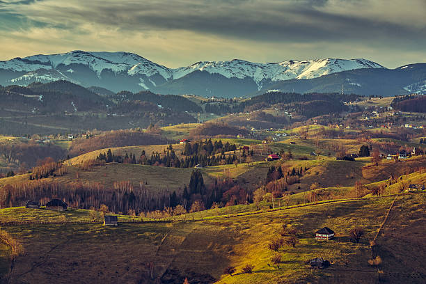 Romanian countryside landscape Morning countryside landscape with traditional Romanian scattered houses in the valleys of Bucegi mountains uphill in Sirnea village, Brasov county, Romania. bucegi mountains stock pictures, royalty-free photos & images