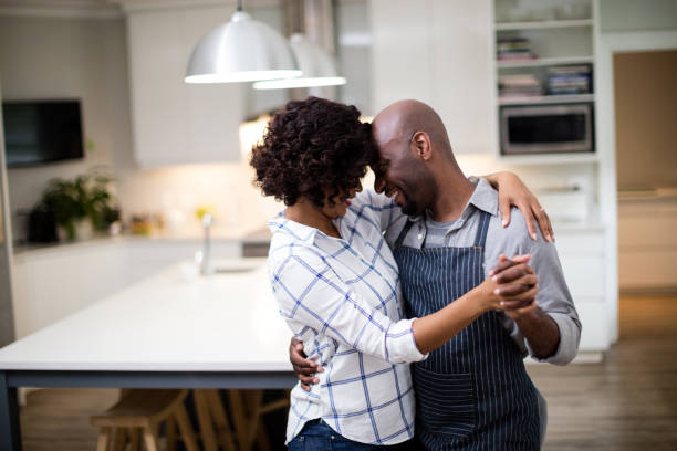Romantic couple dancing in kitchen Romantic couple dancing in kitchen at home 30 39 years stock pictures, royalty-free photos & images