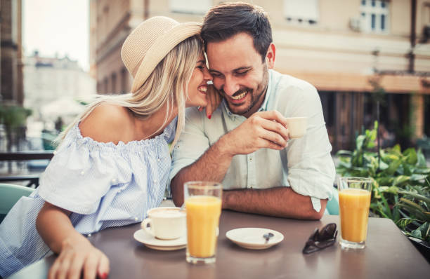 Romantic couple in the cafe. Dating, love, relationships Flirting in a cafe. Beautiful loving couple sitting in a cafe drinking coffee and enjoying in conversation. Love, romance, dating flirting stock pictures, royalty-free photos & images