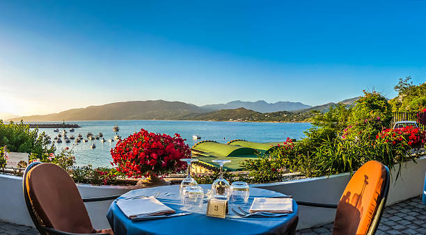 romantic dinner place with idyllic view of coastscape at sunset - sunset dining stockfoto's en -beelden
