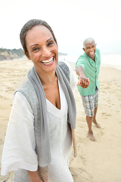 Romantic Senior Couple Playing on the Beach stock photo