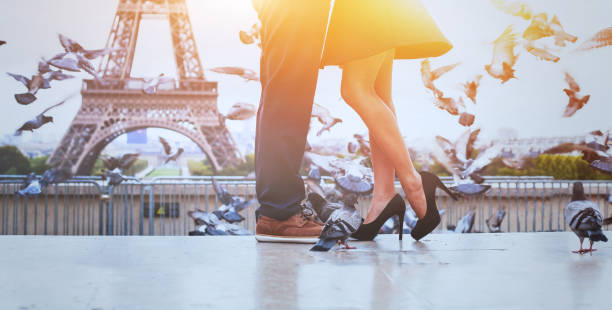 romantic travel background banner, honeymoon in Paris romantic travel background banner, honeymoon in Paris, legs of unrecognizable couple eiffel tower paris photos stock pictures, royalty-free photos & images