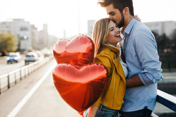 Romantic young couple in love, hugging on the street Romantic young couple in love, hugging on the street on valentine day boyfriend photos stock pictures, royalty-free photos & images