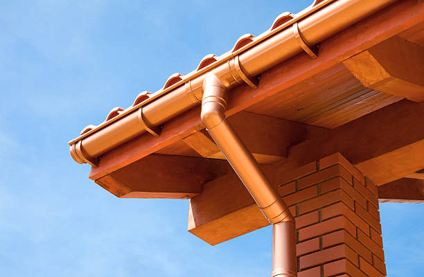 Roof Close-up of rain gutter and downspout. roof beam stock pictures, royalty-free photos & images