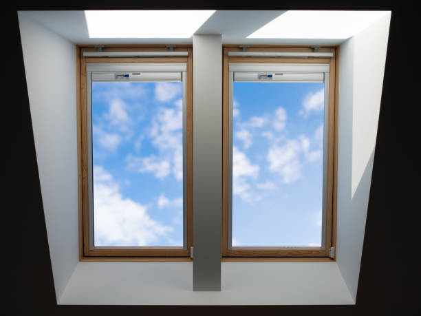 roof windows overlooking the blue slightly cloudy sky stock photo