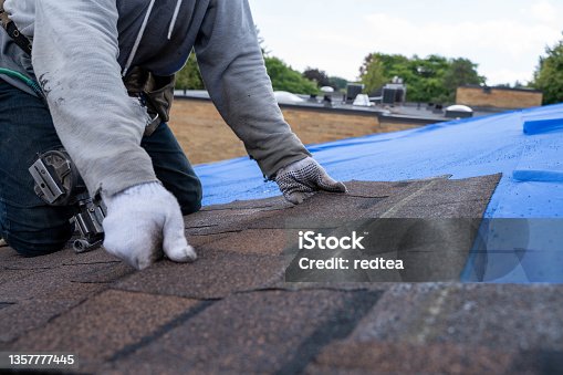 istock Roofers installing new roof on house 1357777445