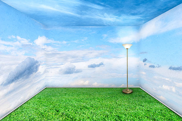 Room with all walls appearing as the sky and floor as grass stock photo