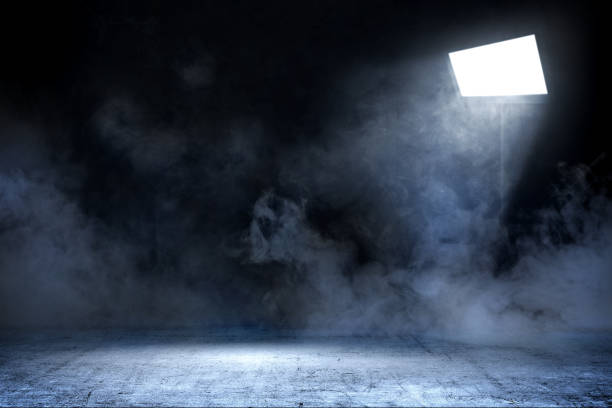 Room with concrete floor and smoke with light from spotlights stock photo