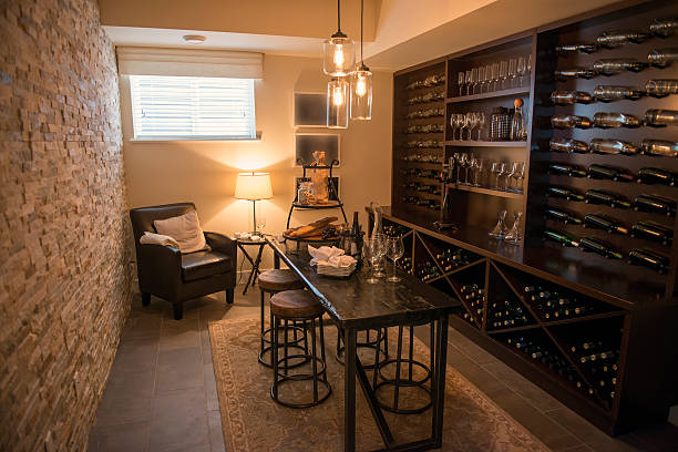 Room with dark dining furniture and wine filled shelves a nice wine cellar / elegant, luxurious / also full of wine cellar stock pictures, royalty-free photos & images