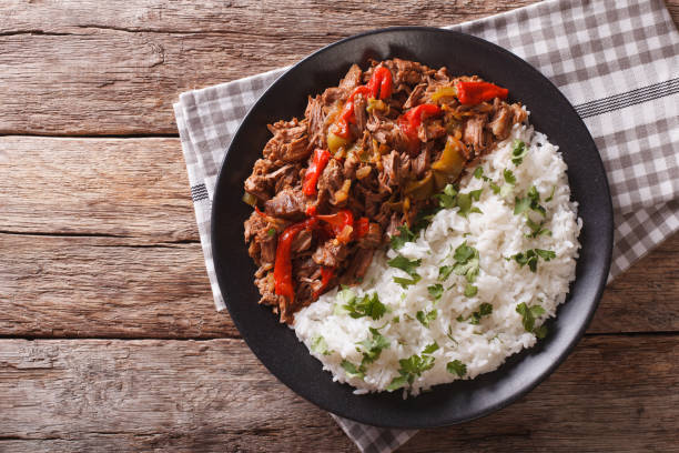 ropa vieja: beef stew in tomato sauce with vegetables and rice. horizontal top view stock photo