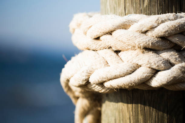 rope attached to the pier rope attached to the pier moored stock pictures, royalty-free photos & images