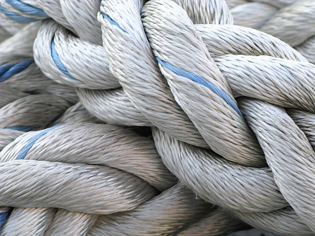 Rope Nautical Marina A close up of a knotted rope at a marina. moor photos stock pictures, royalty-free photos & images