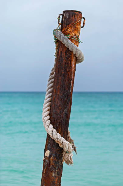 Rope tied around a wooden pole stock photo
