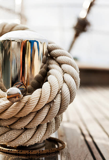 Rope tighten on Cleat. Hawser. Sailing Yacht. Hawser. Deck. Close-up. stock photo