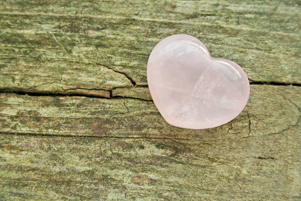 rose quartz rose quartz heart on wooden ground rose quartz stock pictures, royalty-free photos & images