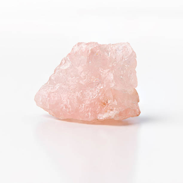 Rose quartz raw silicon dioxide mineral isolated on white background. stock photo