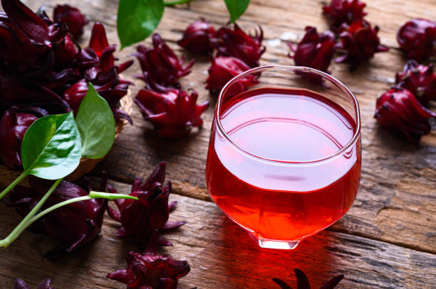 Roselle juice on wooden background, herbal organic tea for good healthy stock photo