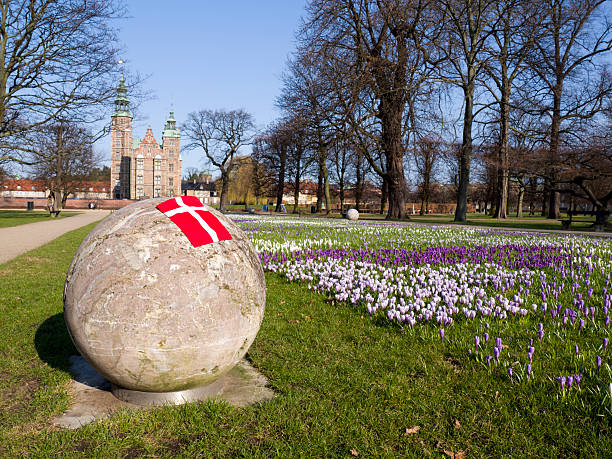 Rosenborg Castle at spring and the Danish flag stock photo
