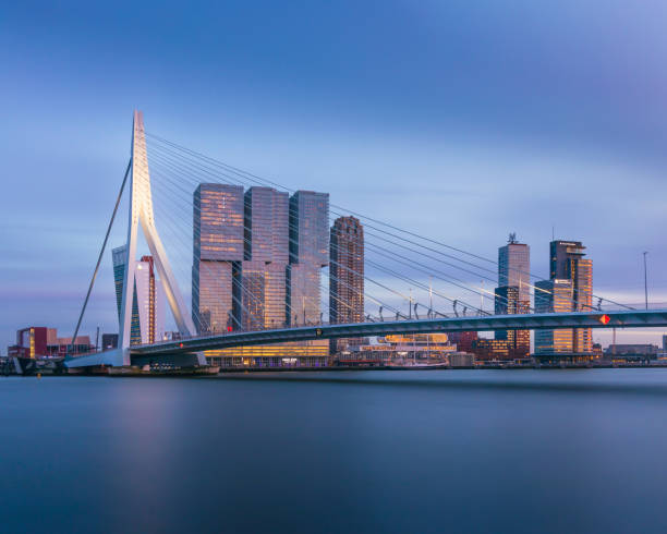 Rotterdam skyline architecture and Erasmus bridge at dusk, smooth evening sky stock photo