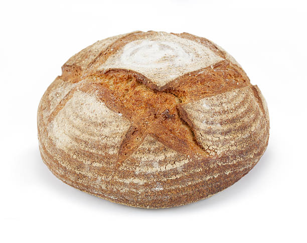 round Artisan crusty loaf a fabulous sour dough crusty Artisan loaf with a thick crusty top (with diagonal cuts that allow the bread to expand evenly in the baking tin). Artisan bread is made using traditional methods and largely by hand, in small batches. It is also baked more slowly, allowing the flour to be properly fermented, to allow “real” flavours to develop.  artisanal food and drink stock pictures, royalty-free photos & images