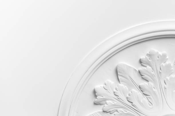 Round decorative clay stucco relief molding Round decorative clay stucco relief molding with floral ornaments on white ceiling in abstract classical style interior moulding trim stock pictures, royalty-free photos & images