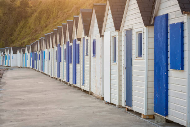 Row of blue and white beach huts at Barneville-Carteret Row of blue and white beach huts at Barneville-Carteret, Cotentin peninsula, Normandy, France barneville carteret photos stock pictures, royalty-free photos & images
