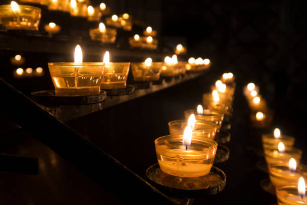 Row of candles in a church a symbol of religion and a memory of beloved ones stock photo