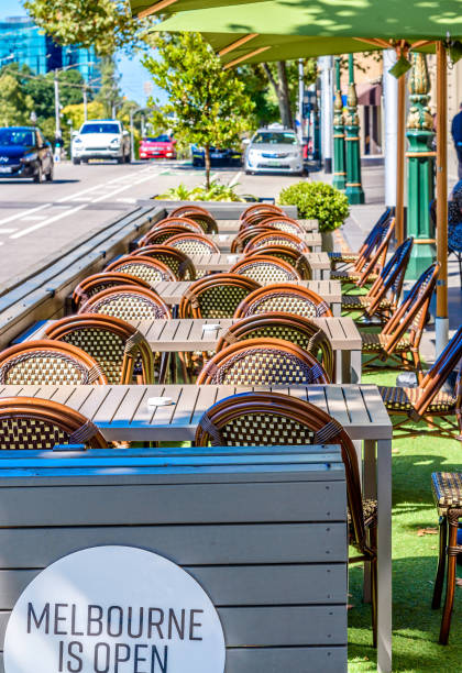 A row of chairs and tables at an outdoor cafe on Spring Street, Melbourne stock photo