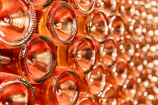 Row of champagne bottles - Wine cellar Bottles of wine stocked in a wine cellar. rose wine stock pictures, royalty-free photos & images