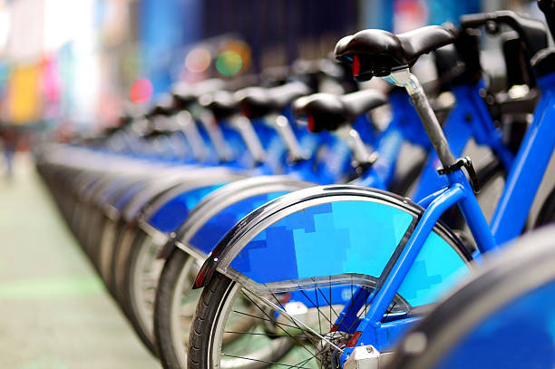 Row of city bikes for rent at docking stations stock photo