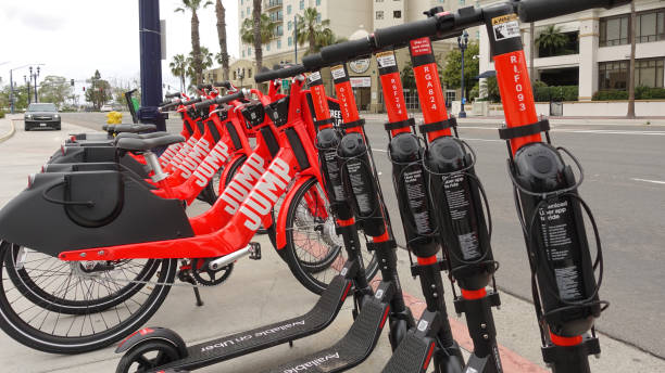 Row of dockless electric JUMP bikes and scooters stock photo