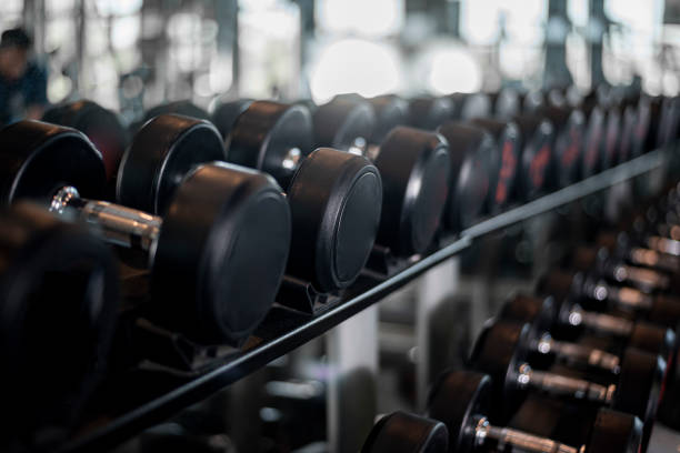 row of dumbbell in fitness gym row of dumbbell in fitness gym renegade dumbbell row stock pictures, royalty-free photos & images