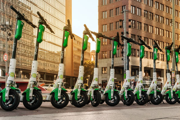 Row of electric E scooters , escooter or e-scooter of the company LIME stock photo
