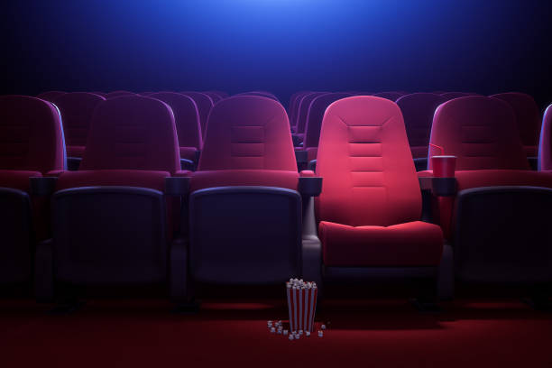 Row of empty red cinema seats Interior of empty dark cinema with rows of red seats with cup holders and popcorn. Concept of entertainment. 3d rendering toned image movie theater stock pictures, royalty-free photos & images